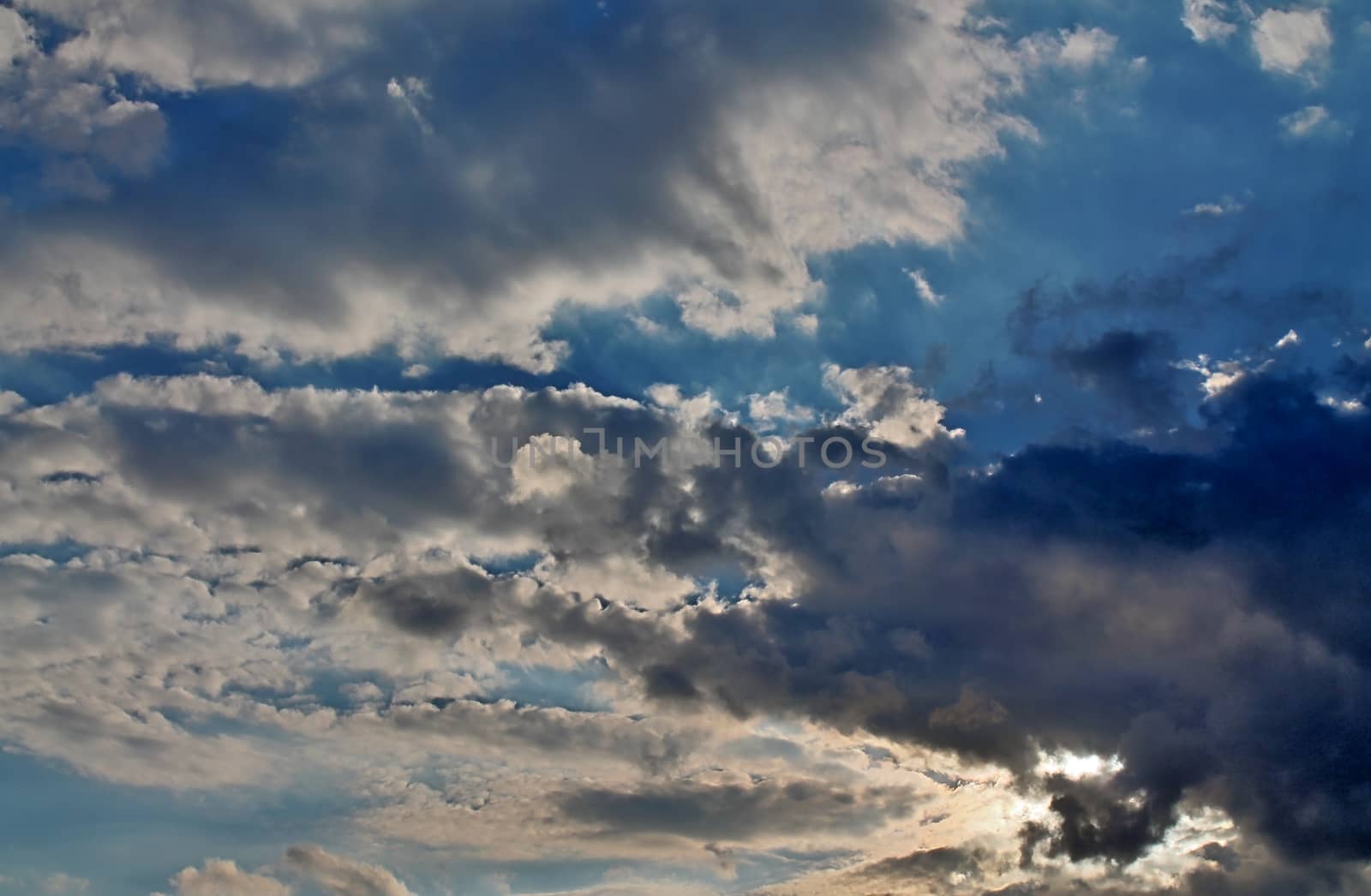 Beautiful panorama of orange and yellow clouds at sunrise and sunset in a blue sky