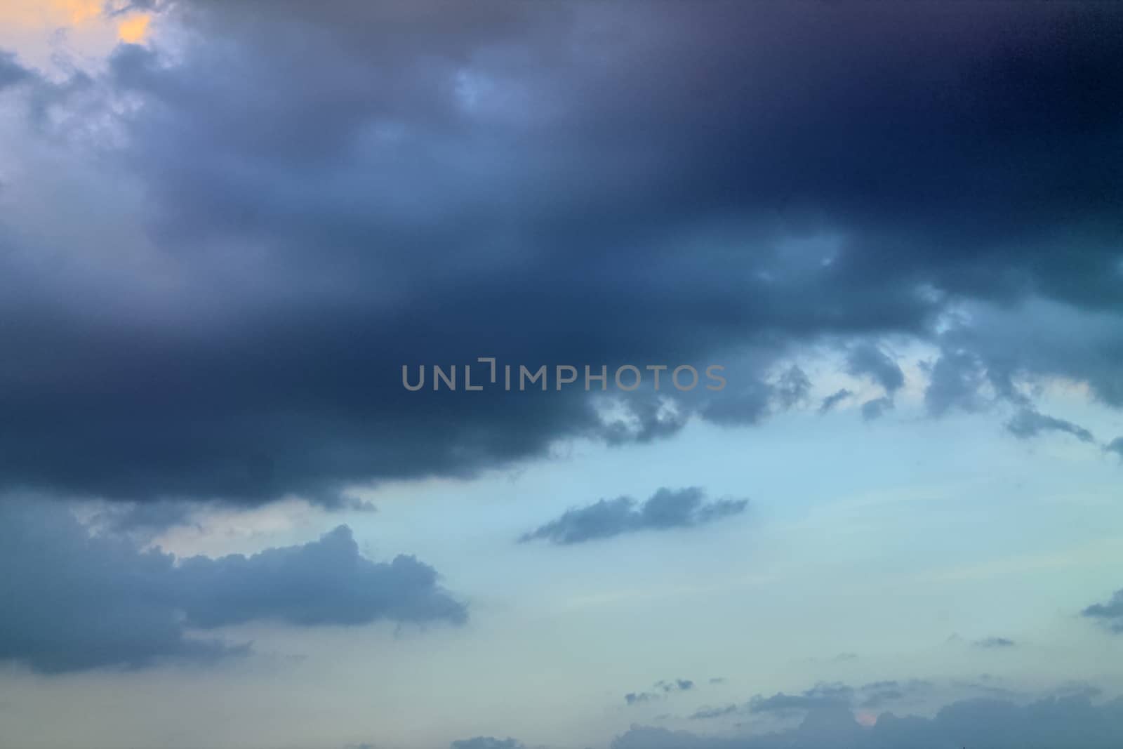 Beautiful panorama of orange and yellow clouds at sunrise and sunset in a blue sky