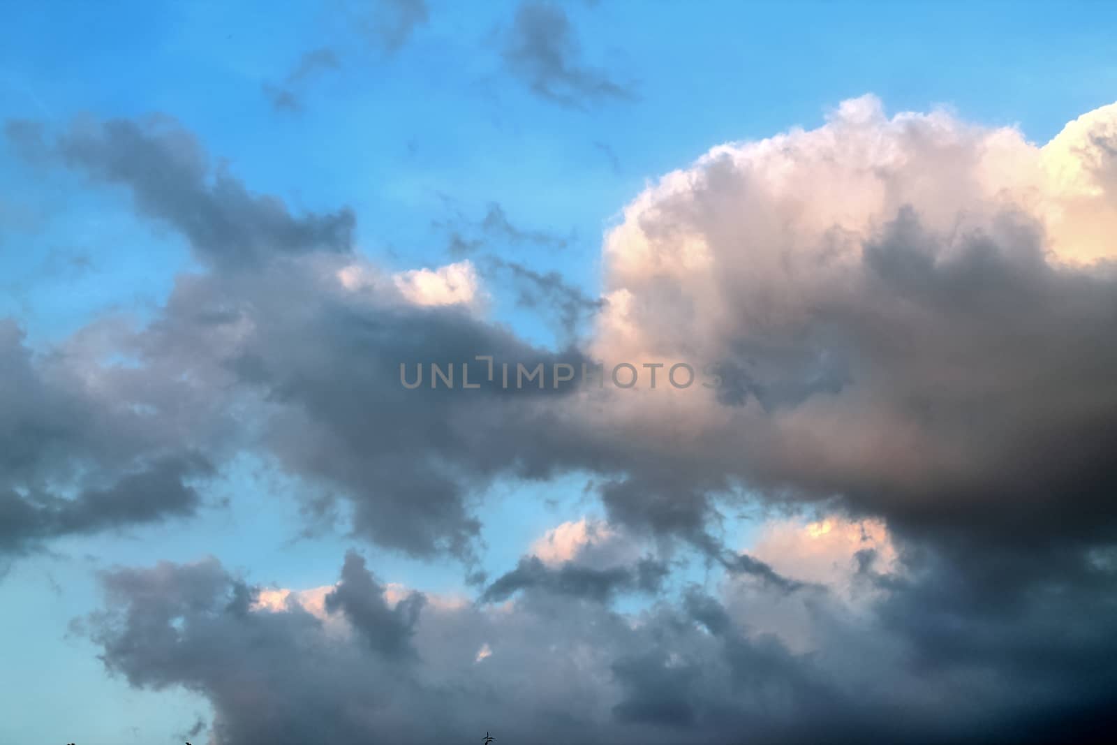 Beautiful panorama of orange and yellow clouds at sunrise and sunset in a blue sky