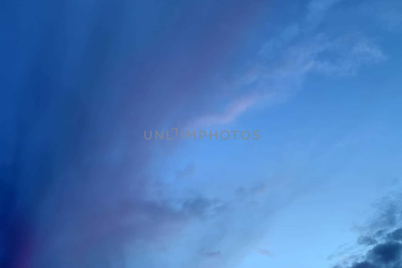 Beautiful panorama of orange and yellow clouds at sunrise and sunset in a blue sky