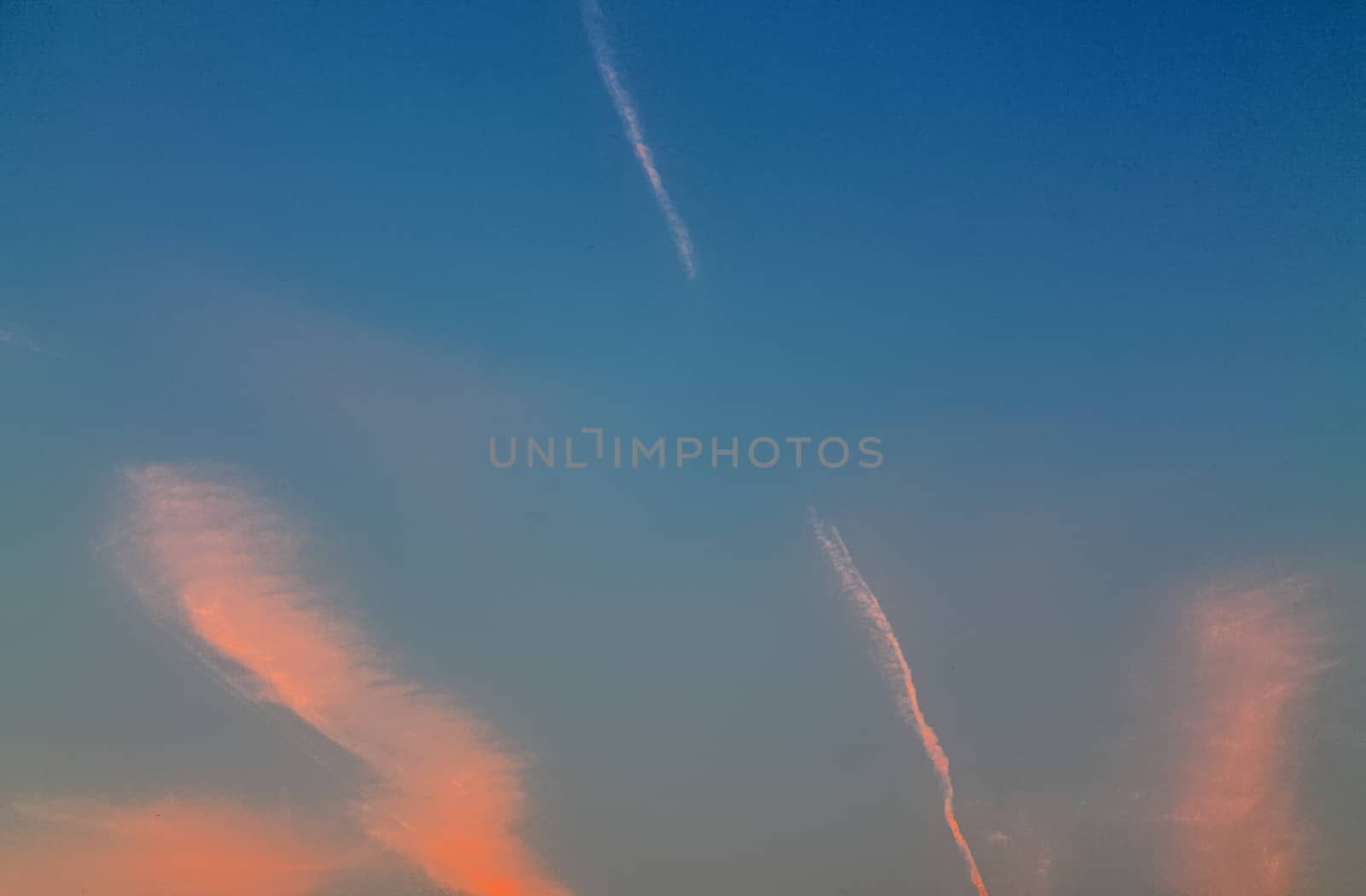 Beautiful panorama of orange and yellow clouds at sunrise and sunset in a blue sky