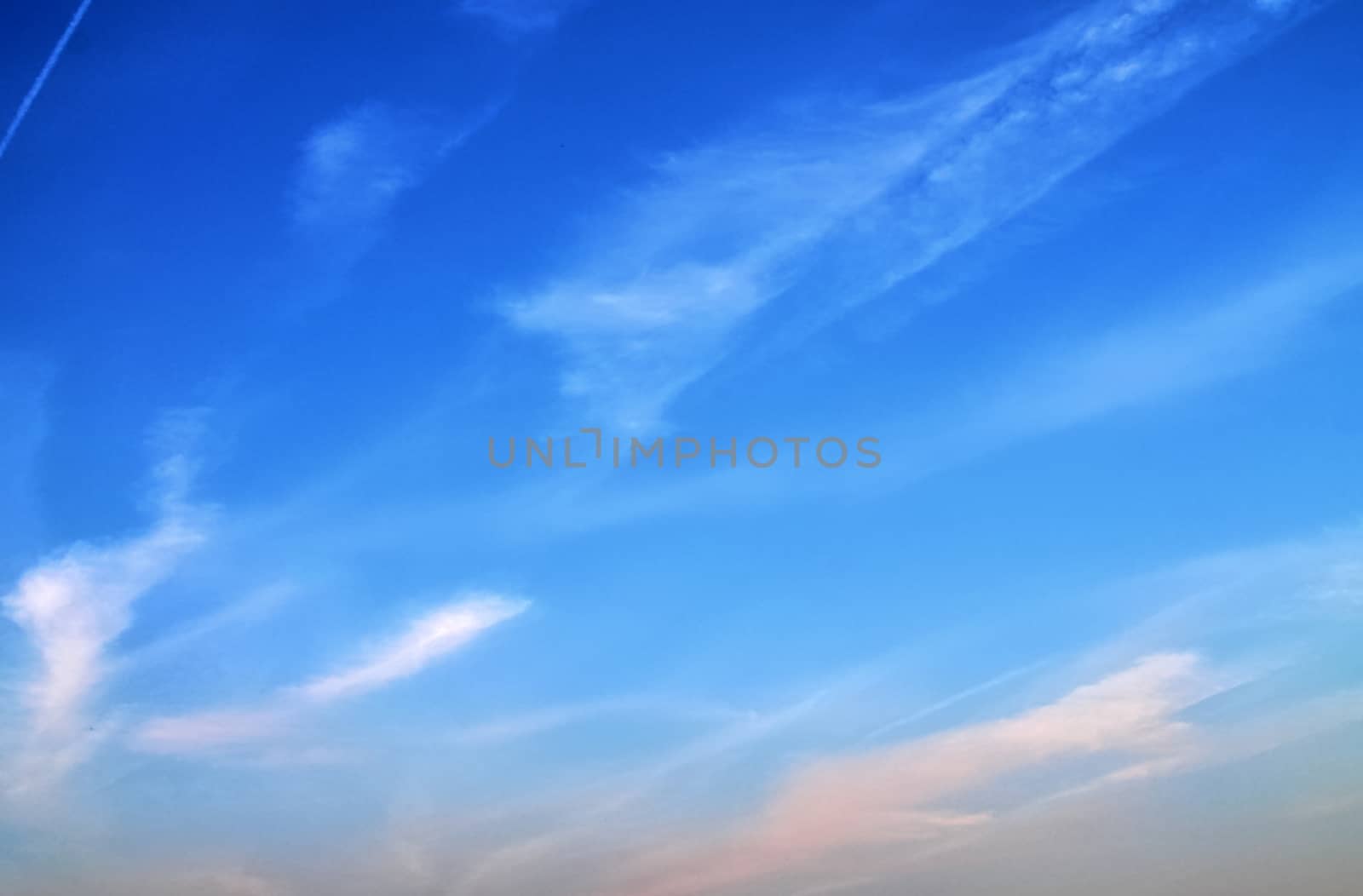 Beautiful panorama of orange and yellow clouds at sunrise and sunset in a blue sky