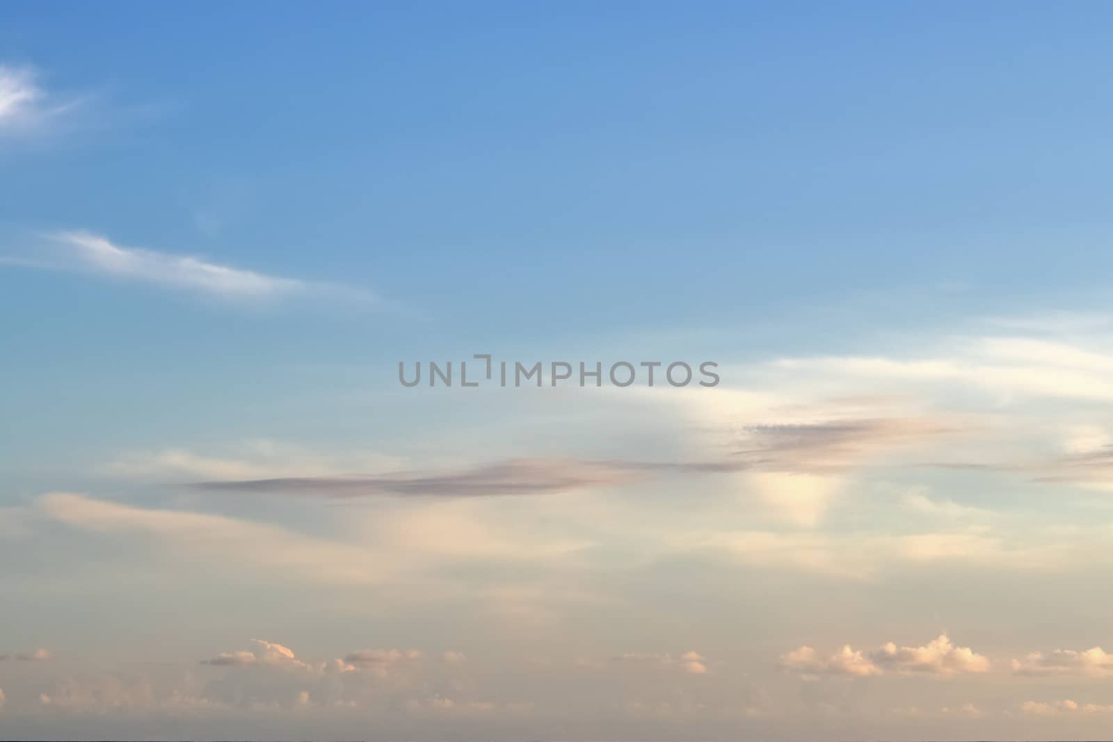 Beautiful panorama of orange and yellow clouds at sunrise and sunset in a blue sky