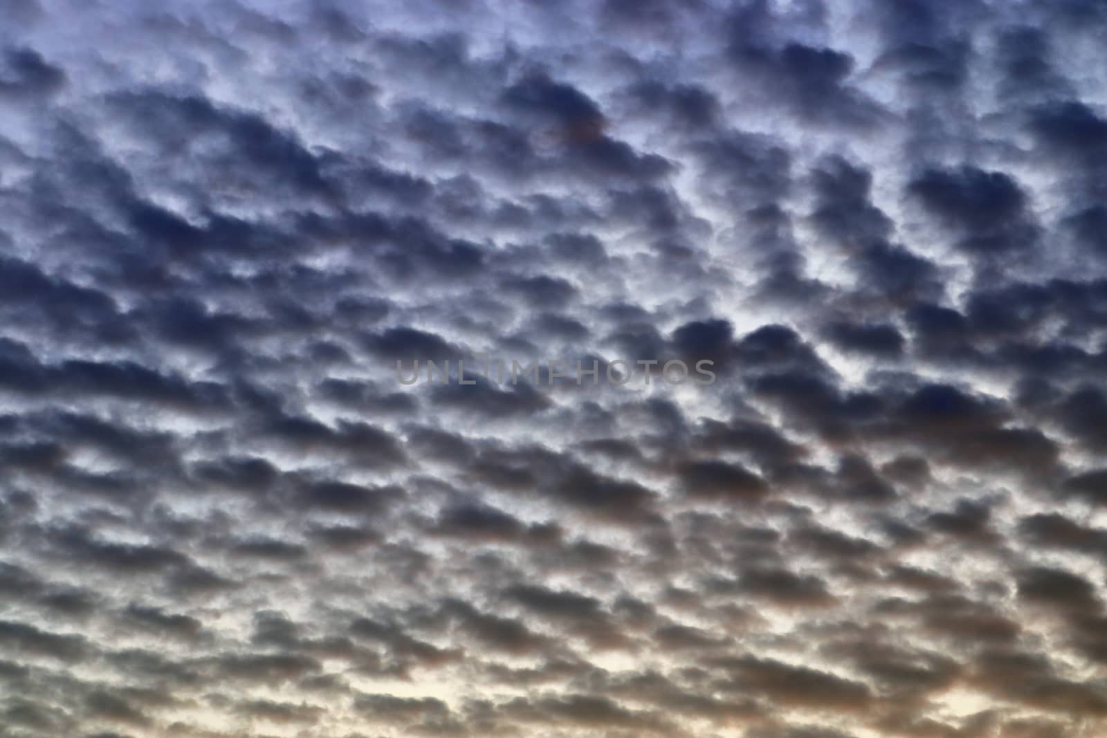 Beautiful panorama of orange and yellow clouds at sunrise and sunset in a blue sky