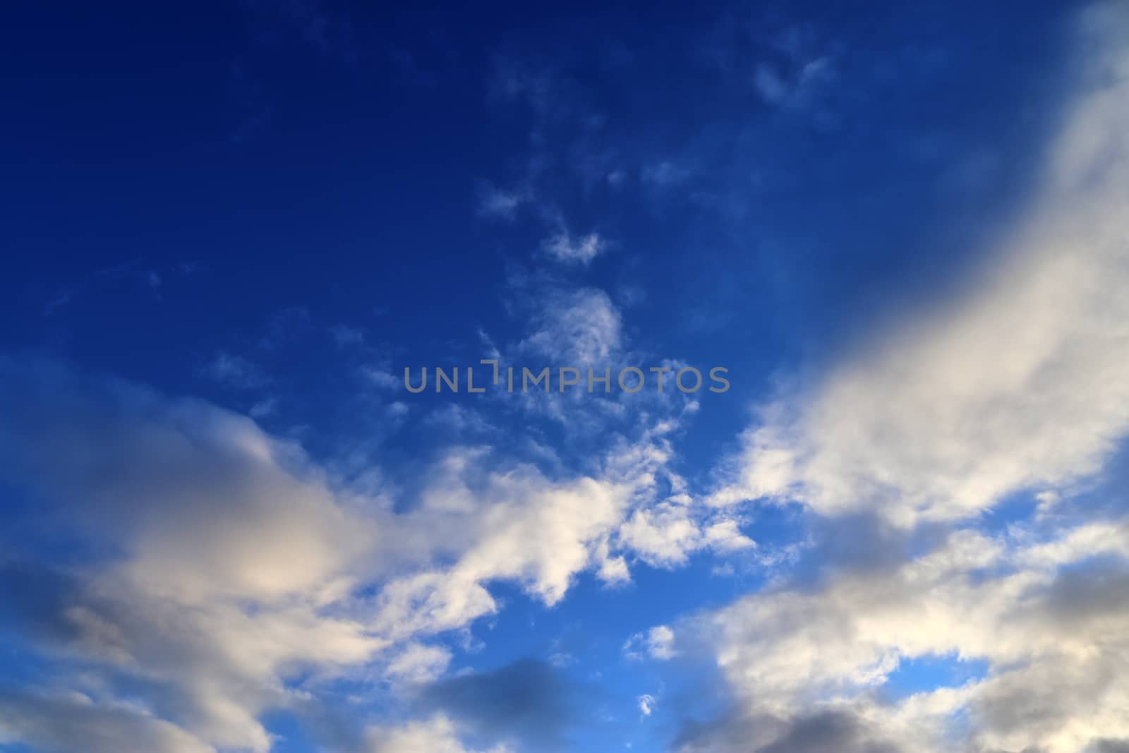 Beautiful panorama of orange and yellow clouds at sunrise and sunset in a blue sky