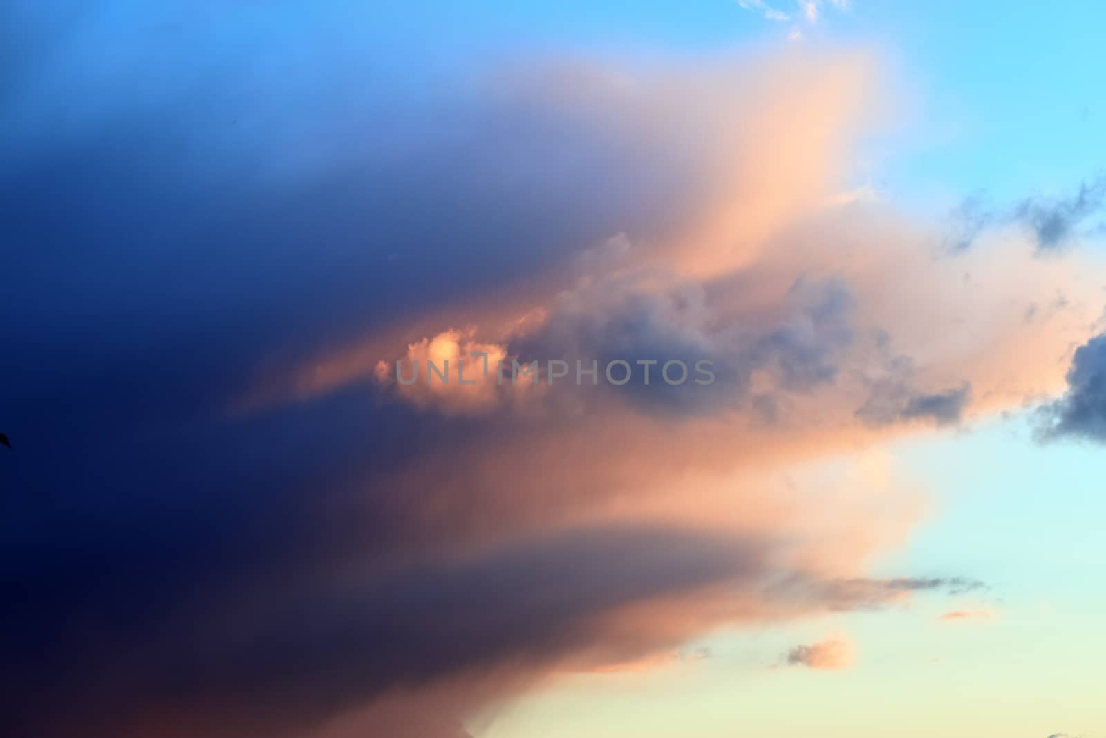 Beautiful panorama of orange and yellow clouds at sunrise and sunset in a blue sky