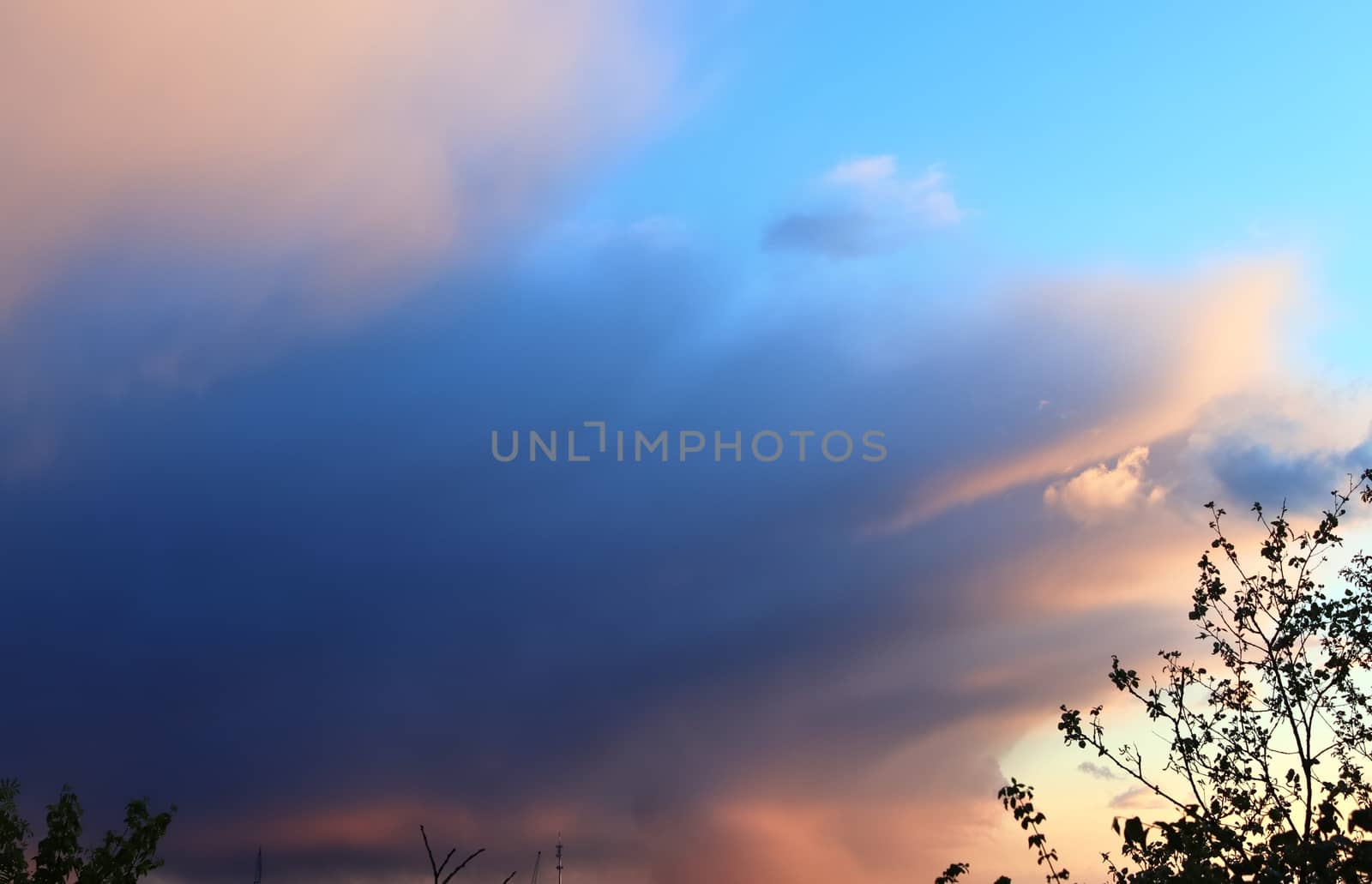 Beautiful panorama of orange and yellow clouds at sunrise and sunset in a blue sky