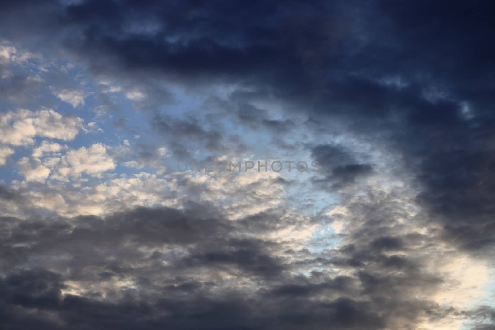 Beautiful panorama of orange and yellow clouds at sunrise and sunset in a blue sky