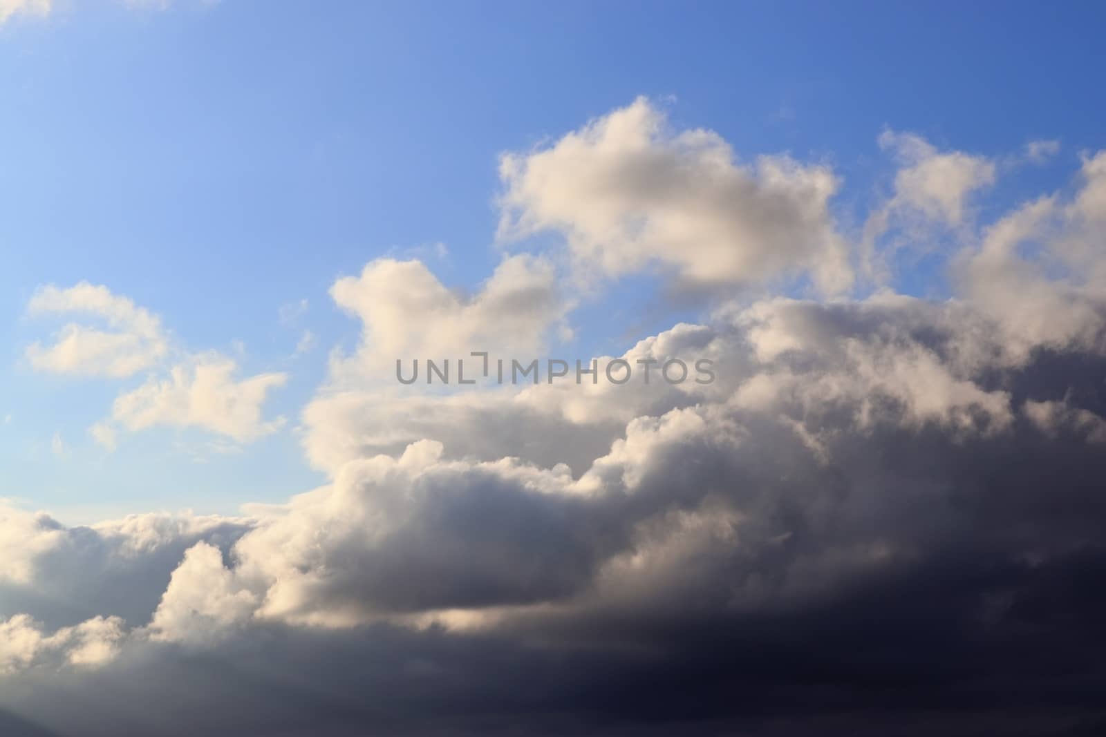 Beautiful panorama of orange and yellow clouds at sunrise and sunset in a blue sky