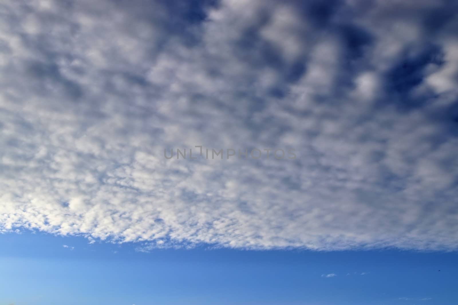 Beautiful panorama of orange and yellow clouds at sunrise and sunset in a blue sky