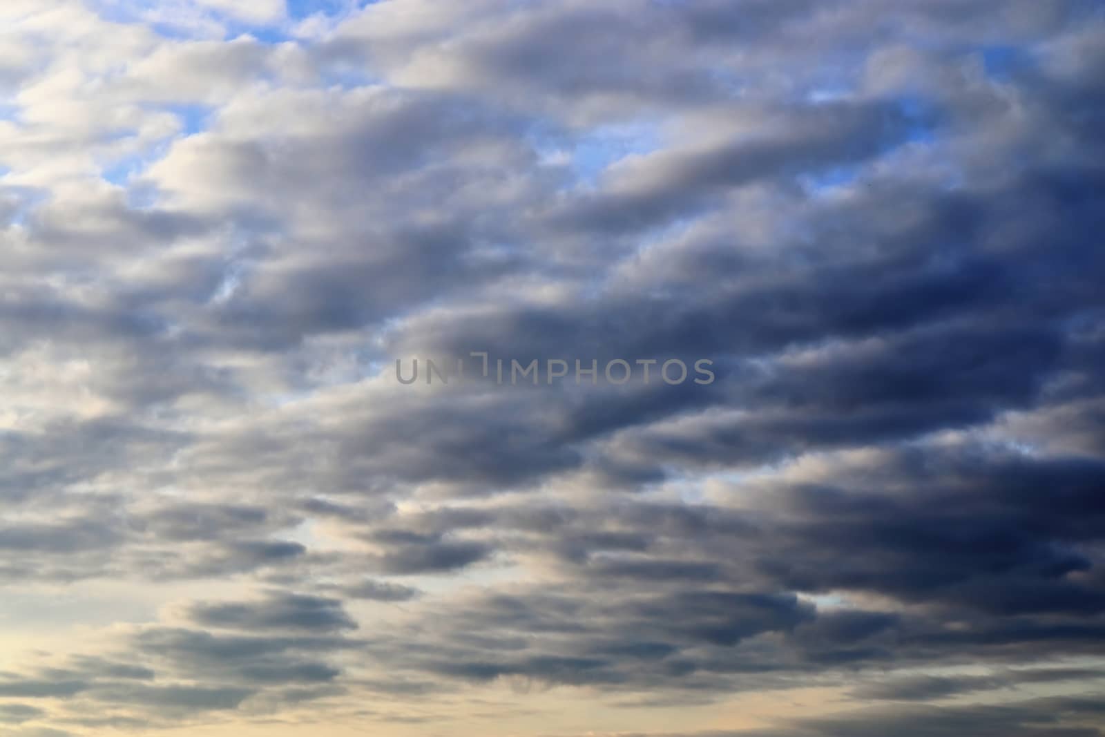 Beautiful panorama of orange and yellow clouds at sunrise and sunset in a blue sky