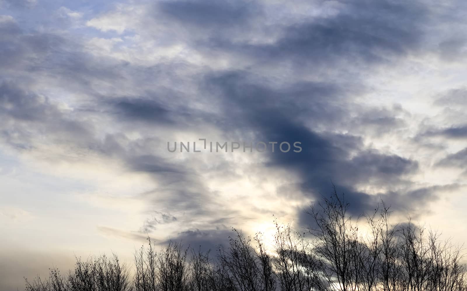 Beautiful panorama of orange and yellow clouds at sunrise and sunset in a blue sky