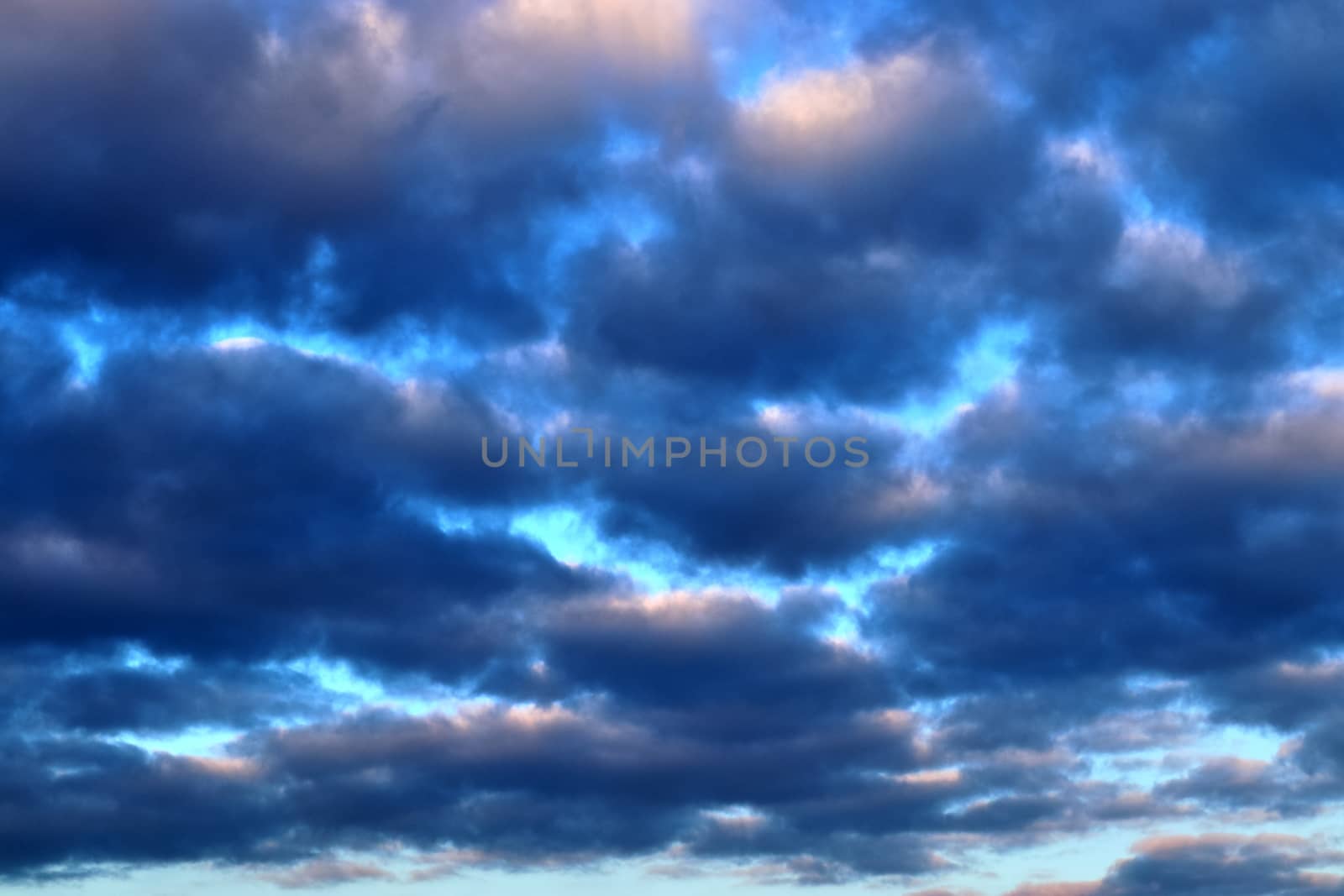 Beautiful panorama of orange and yellow clouds at sunrise and sunset in a blue sky