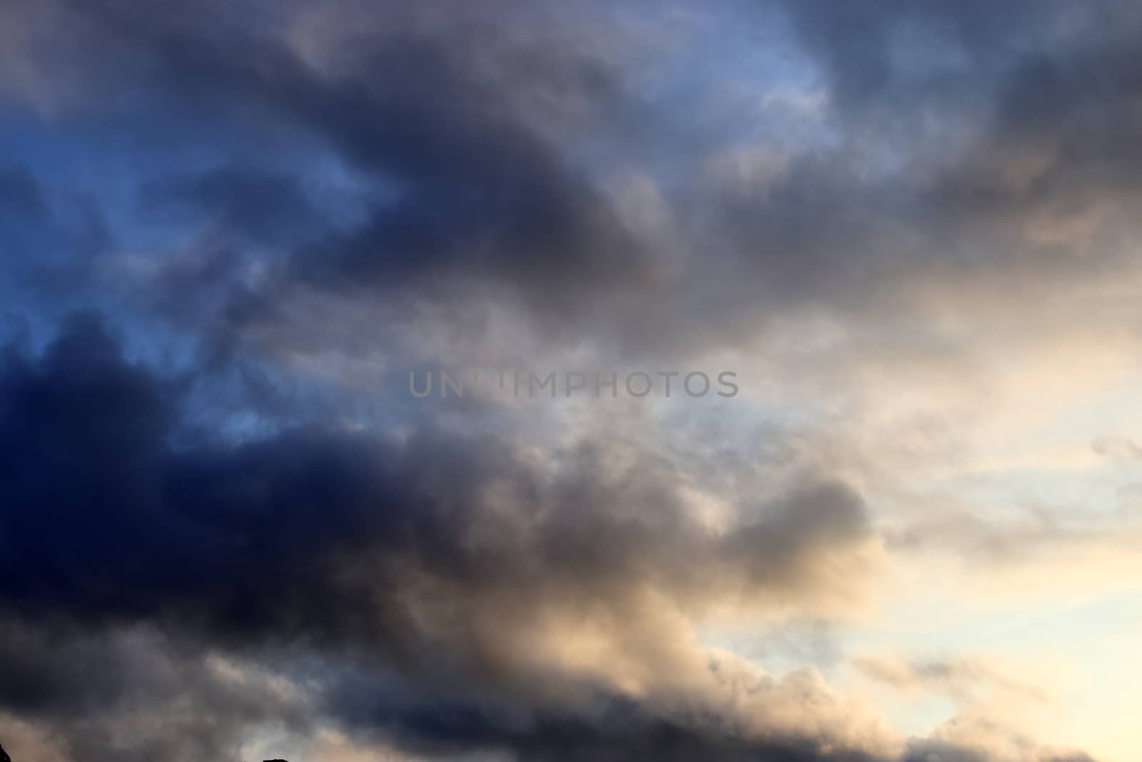 Beautiful panorama of orange and yellow clouds at sunrise and sunset in a blue sky