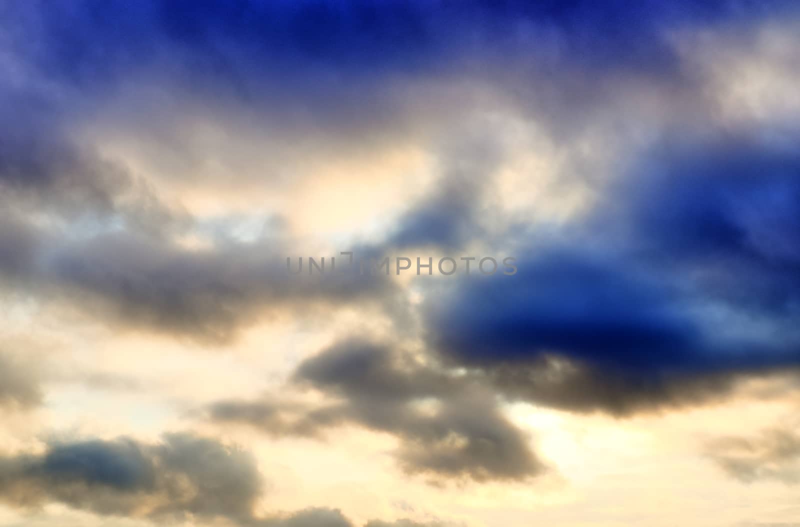 Beautiful panorama of orange and yellow clouds at sunrise and sunset in a blue sky