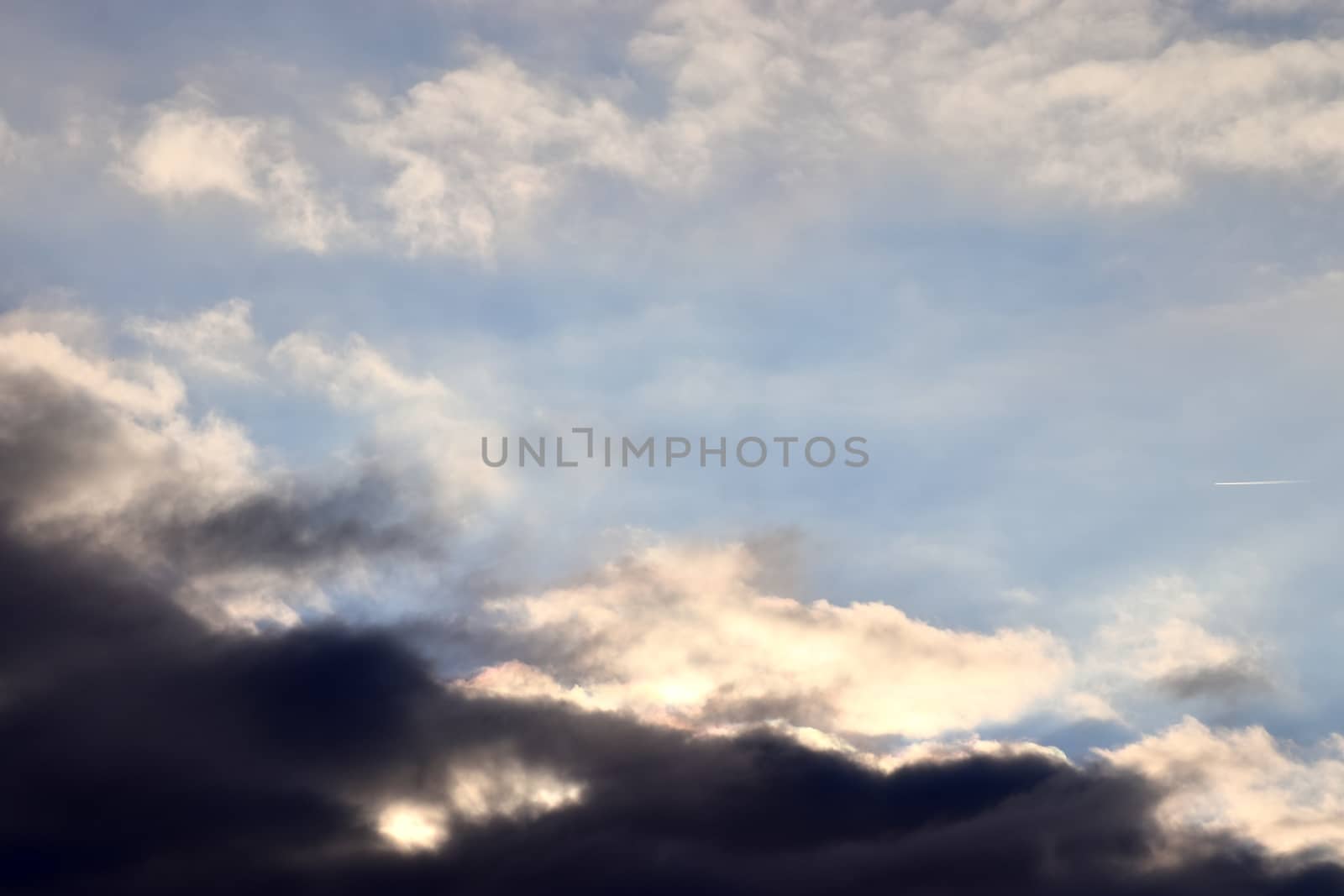 Beautiful panorama of orange and yellow clouds at sunrise and sunset in a blue sky