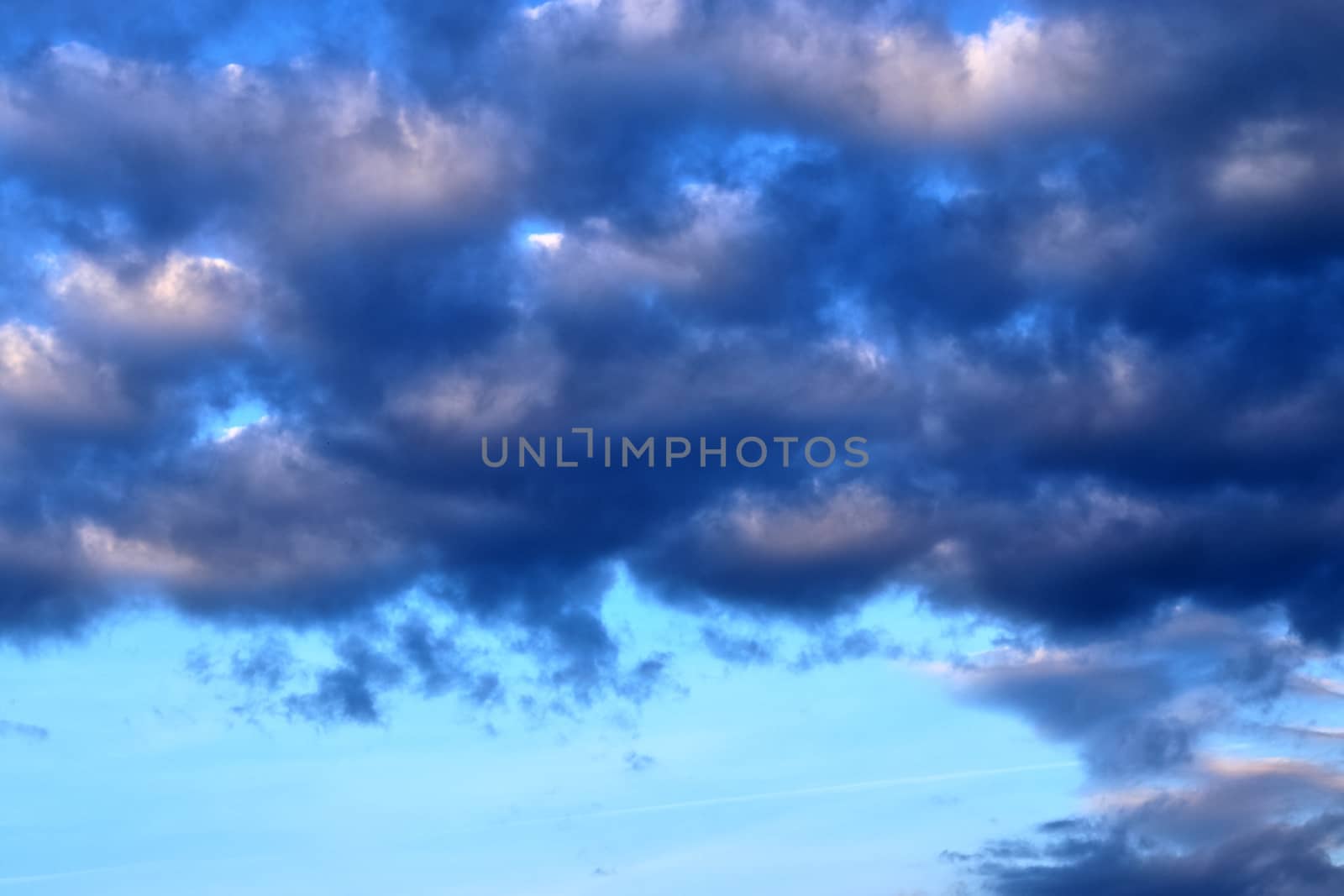 Beautiful panorama of orange and yellow clouds at sunrise and sunset in a blue sky