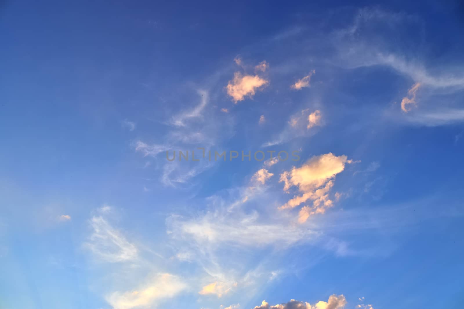 Beautiful panorama of orange and yellow clouds at sunrise and sunset in a blue sky