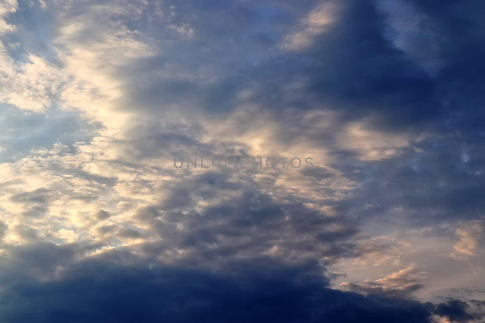 Beautiful panorama of orange and yellow clouds at sunrise and sunset in a blue sky