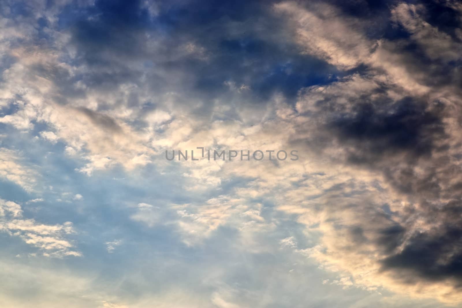 Beautiful panorama of orange and yellow clouds at sunrise and sunset in a blue sky