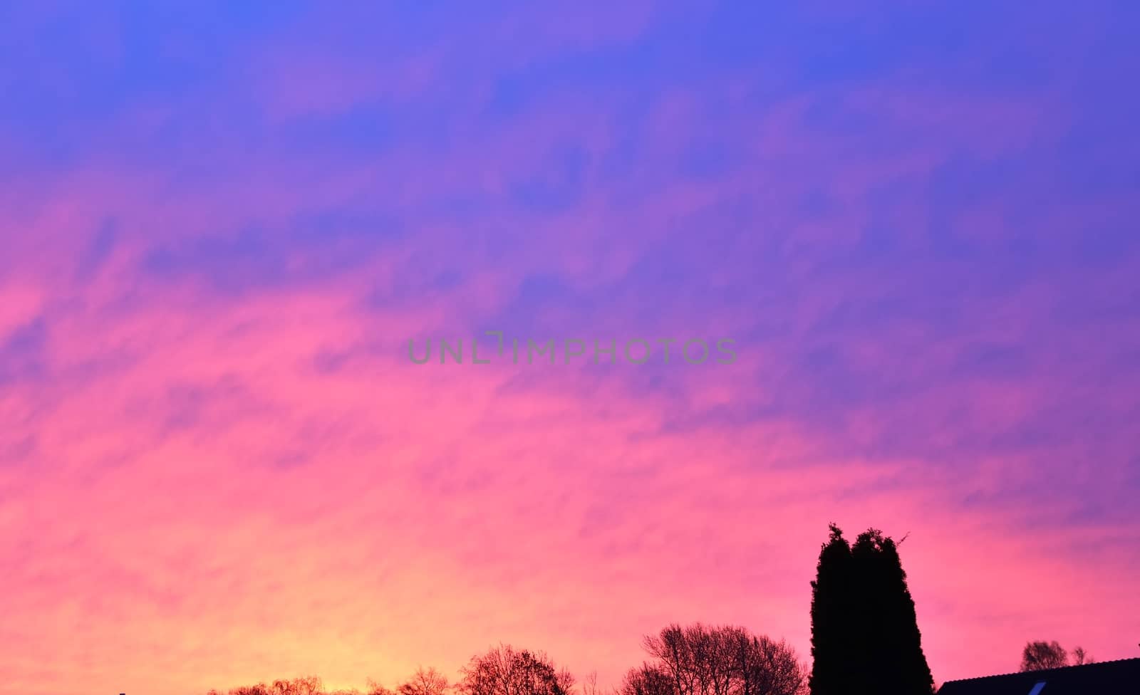 Beautiful panorama of orange and yellow clouds at sunrise and sunset in a blue sky