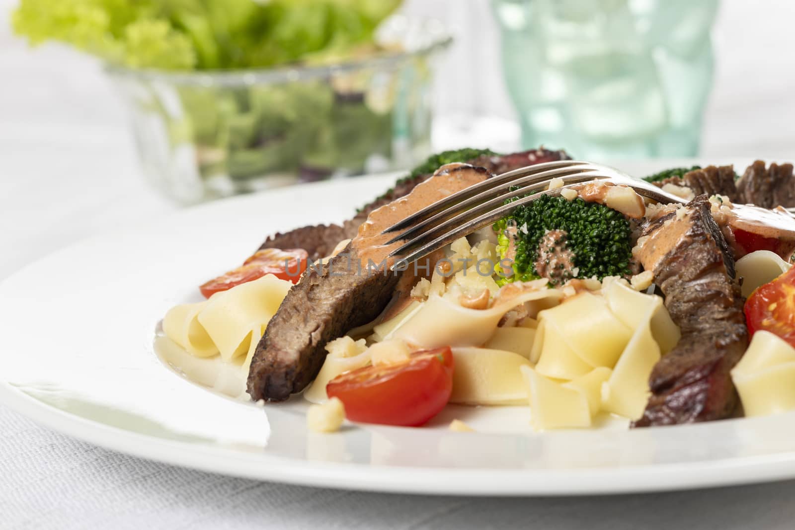 tagliatelli with steak slices on a plate