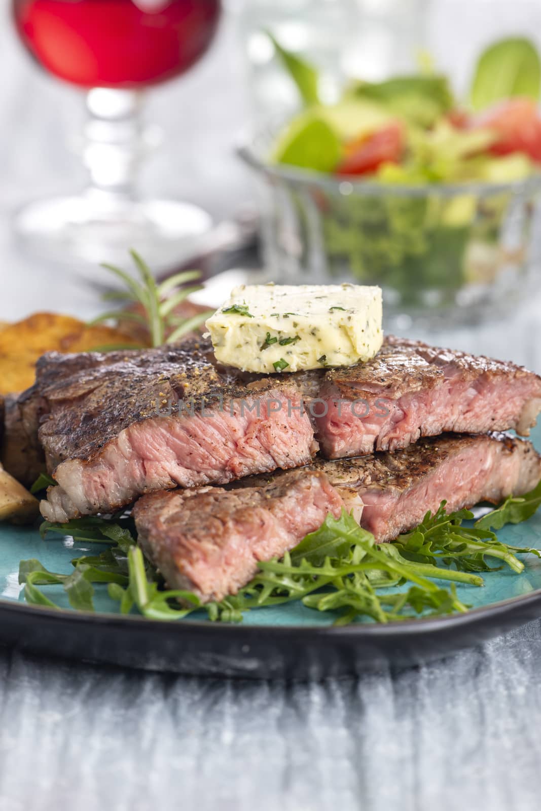 juicy grilled steak on a plate by bernjuer