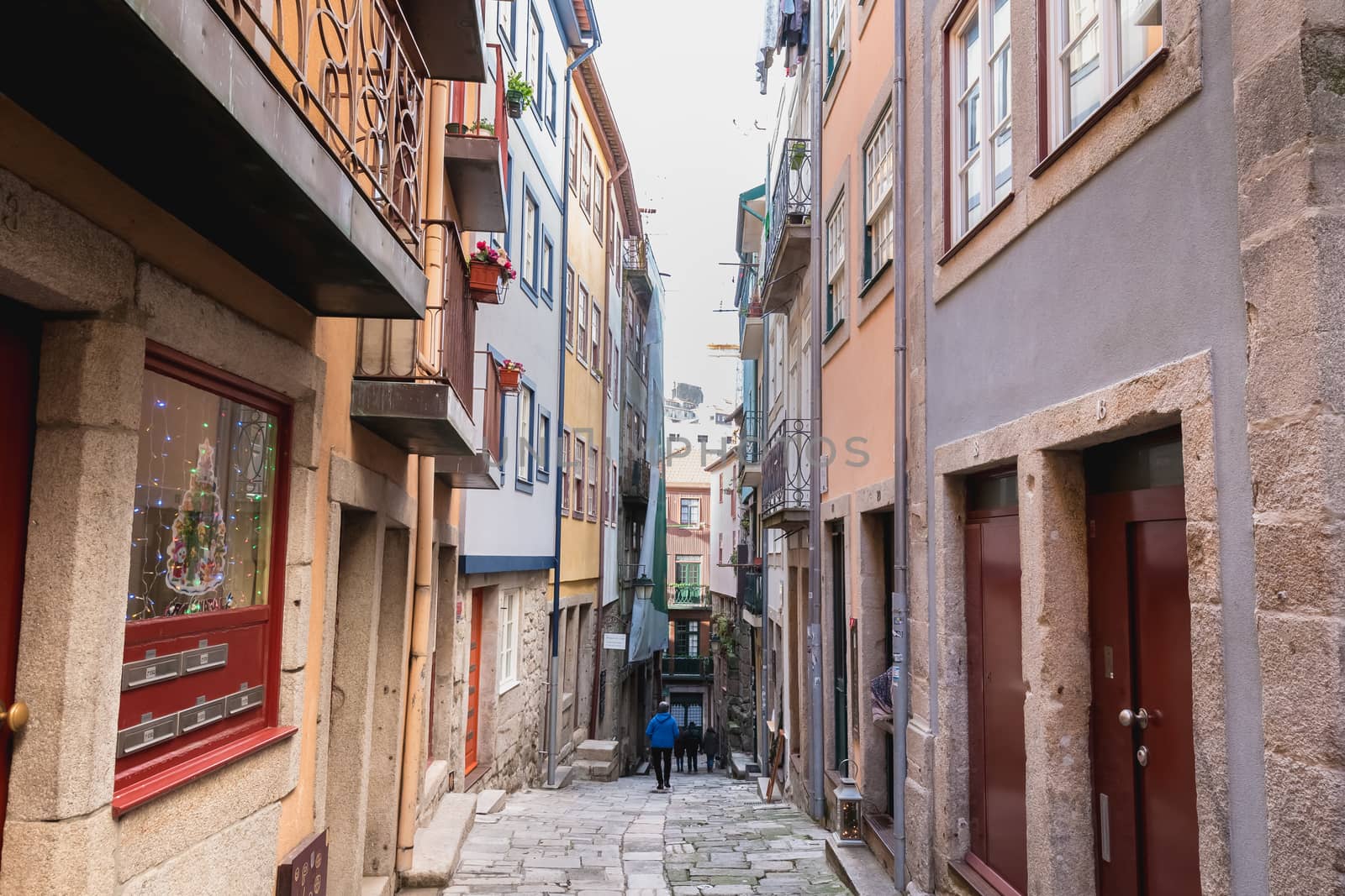 Porto, Portugal - November 30, 2018: Architecture detail and street atmosphere in the historic city center where people walk on a winter day