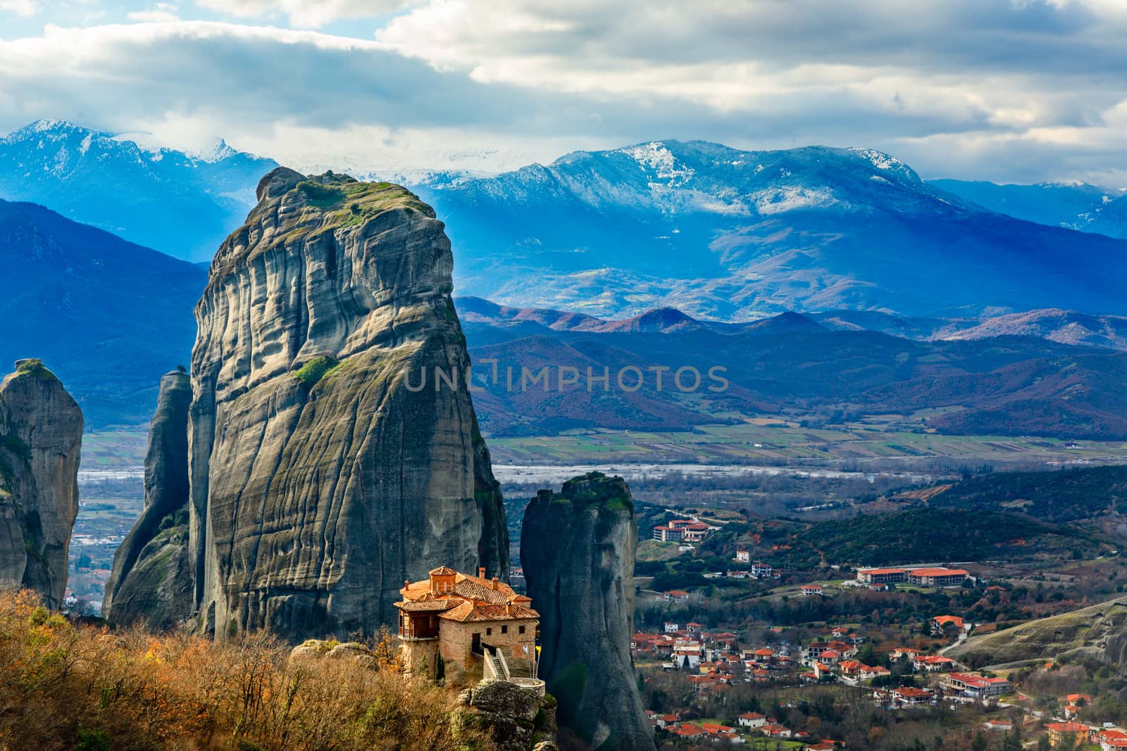 The Holy Monastery of Roussanou among the steep cliffs, with Kastraki village and mountains panorama, Kalampaka, Trikala, Thessaly, Greece