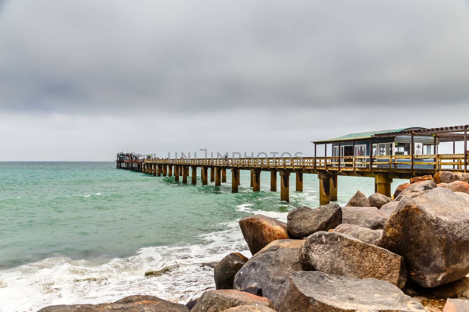 Long pier,and rocky coastline of Swakopmund German colonial town, Namibia