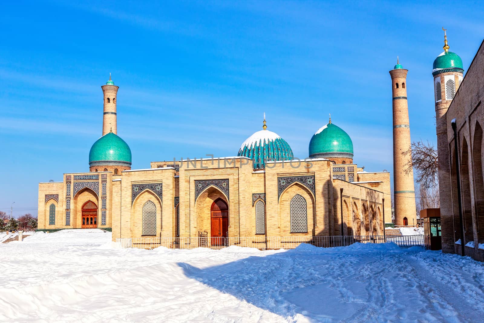 Snow, blue domes and ornated mosques and minarets of Hazrati Imam complex, religious center of Tashkent, Uzbekistan