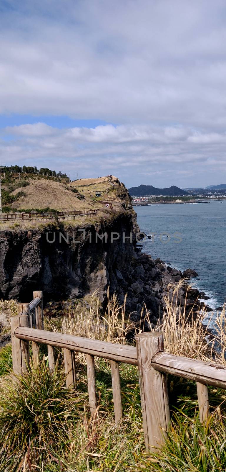 Vertical shot of songaksan, jeju Island, South Korea with ocean in the background