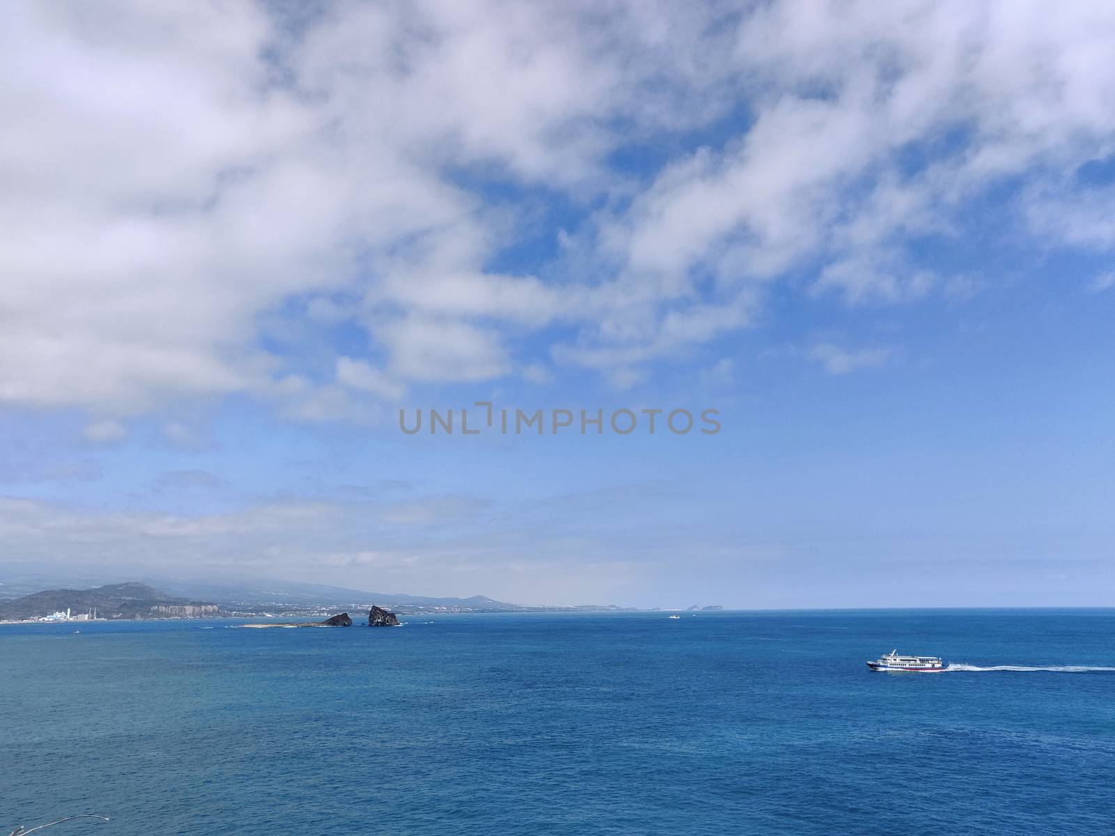 Breathtaking landscape shot of blue sea and cloudy sky in Jeju Island, South Korea