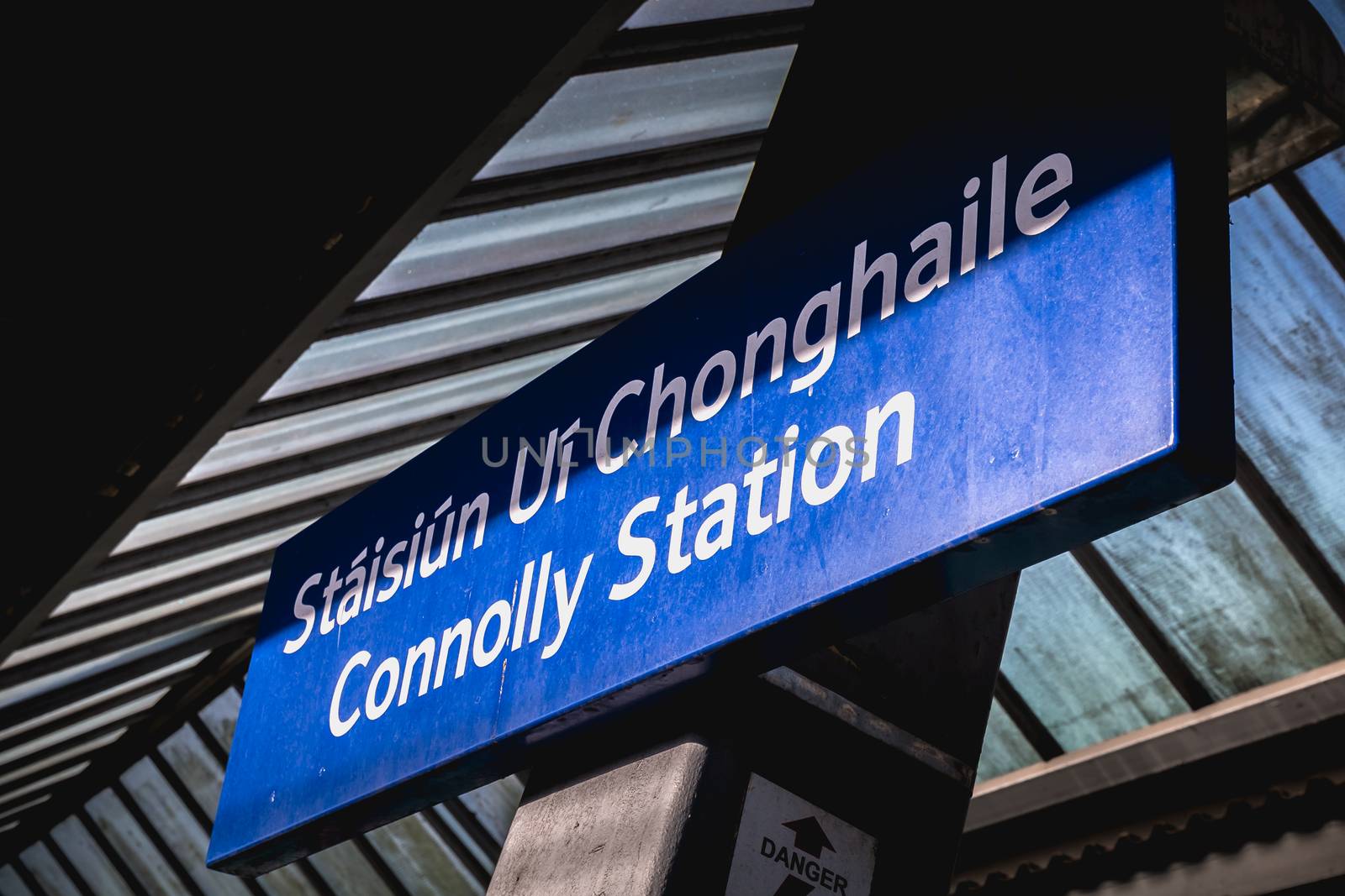 Dublin, Ireland - February 15, 2019: Blue platform sign announcing the name of the station in the Connolly DART train station (Staisiun ui Chonghaile) on a winter day