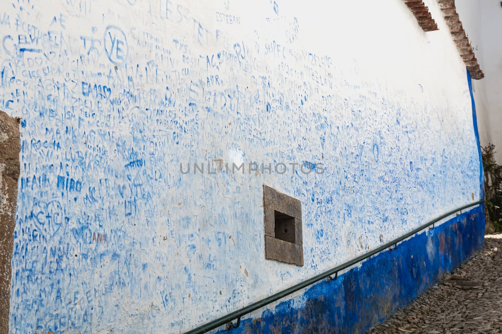 Wall covered with blue signatures in obidos, Portugal by AtlanticEUROSTOXX
