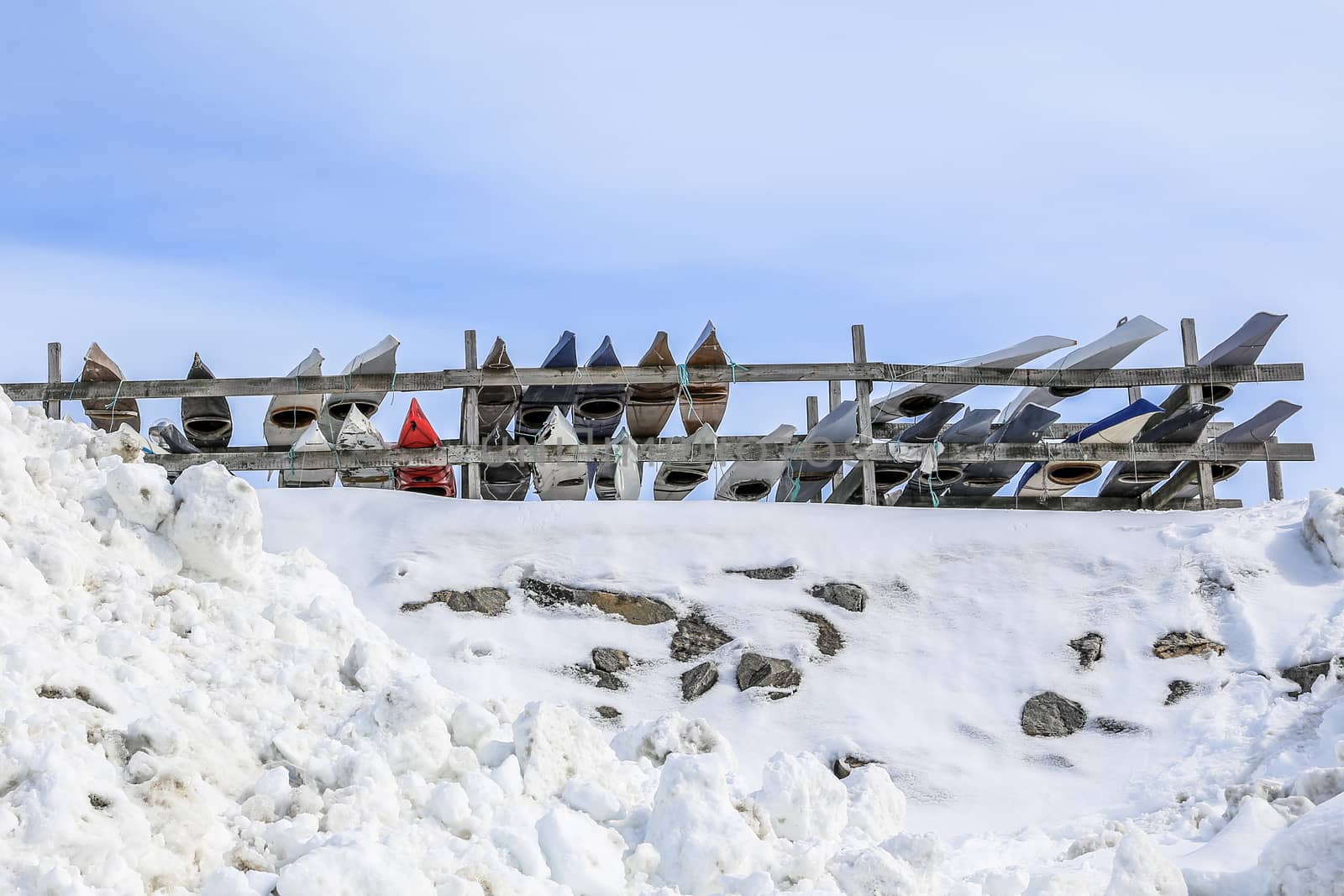 Rows of Inuit kayaks stored for a winter time, Nuuk old city harbor, Greenland