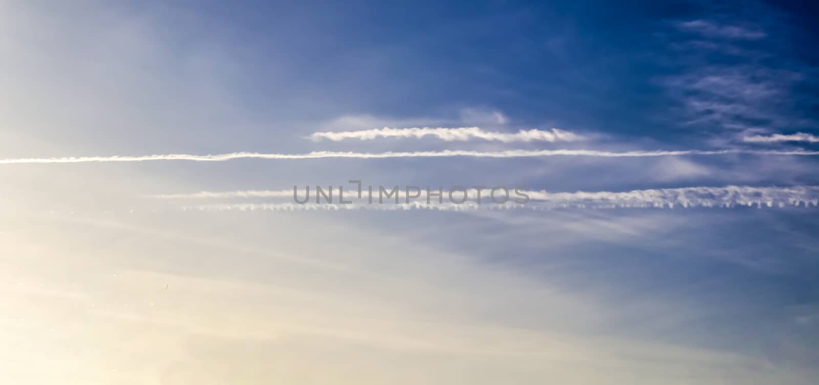 Aircraft condensation contrails in the blue sky inbetween some c by MP_foto71