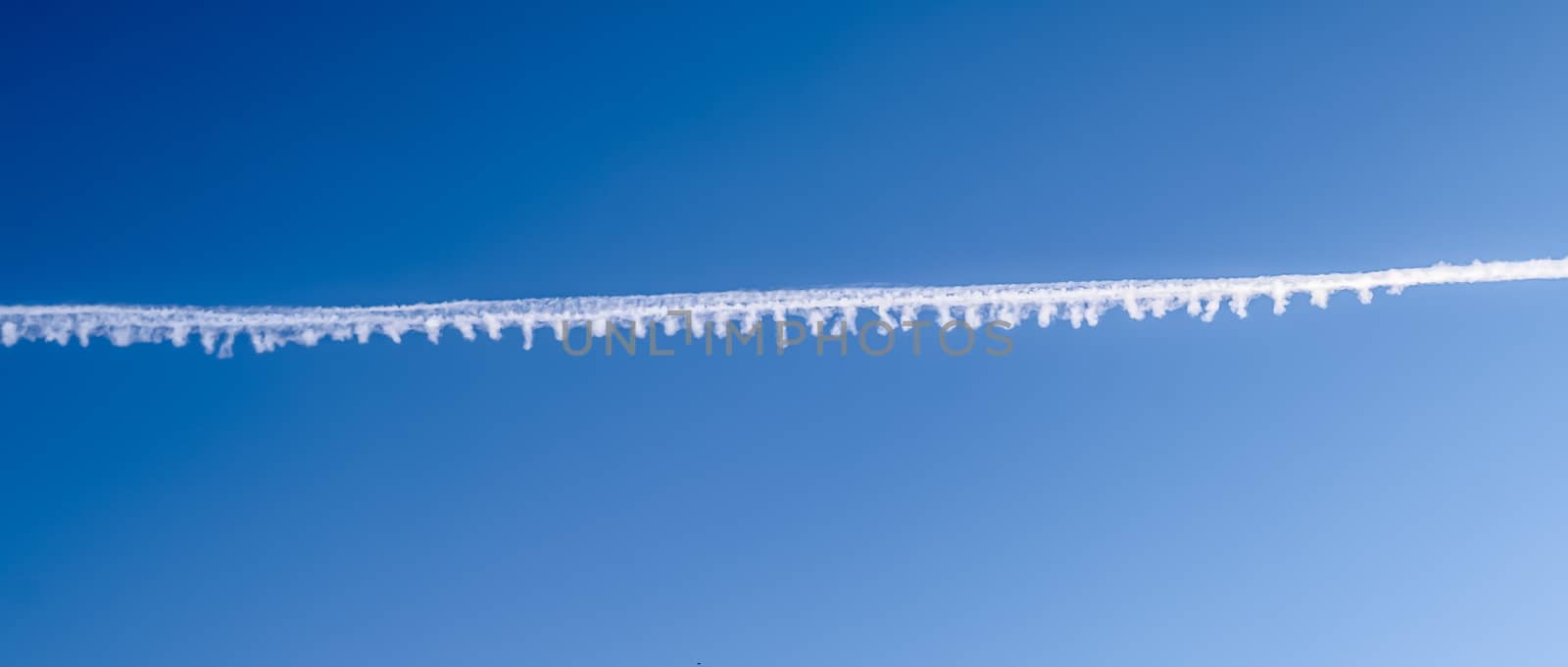 Aircraft condensation contrails in the blue sky inbetween some c by MP_foto71