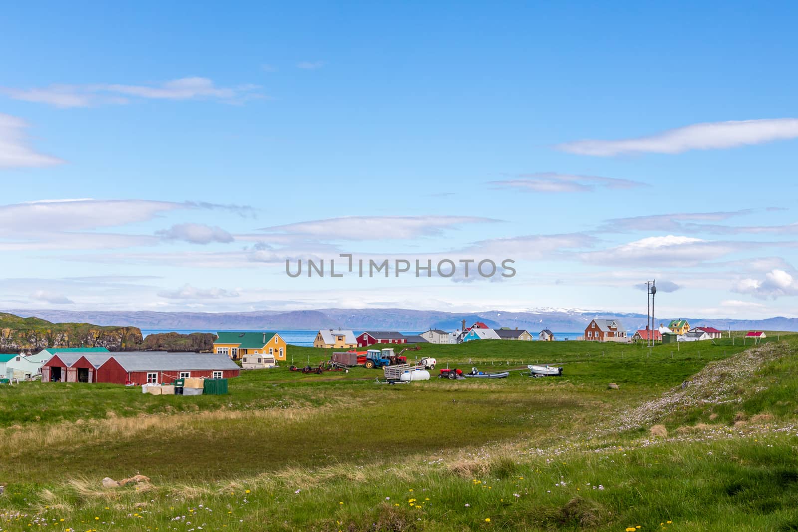 Village with living houses and meadow in foreground and sea  fjo by ambeon