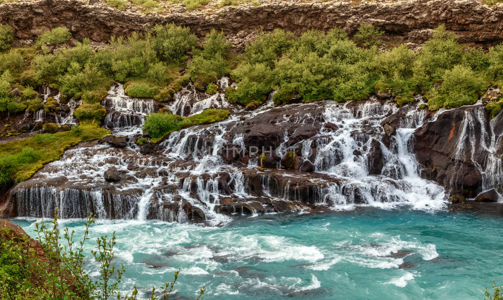 Hraunfossar waterfall powerful streams falling into Hvita river  by ambeon