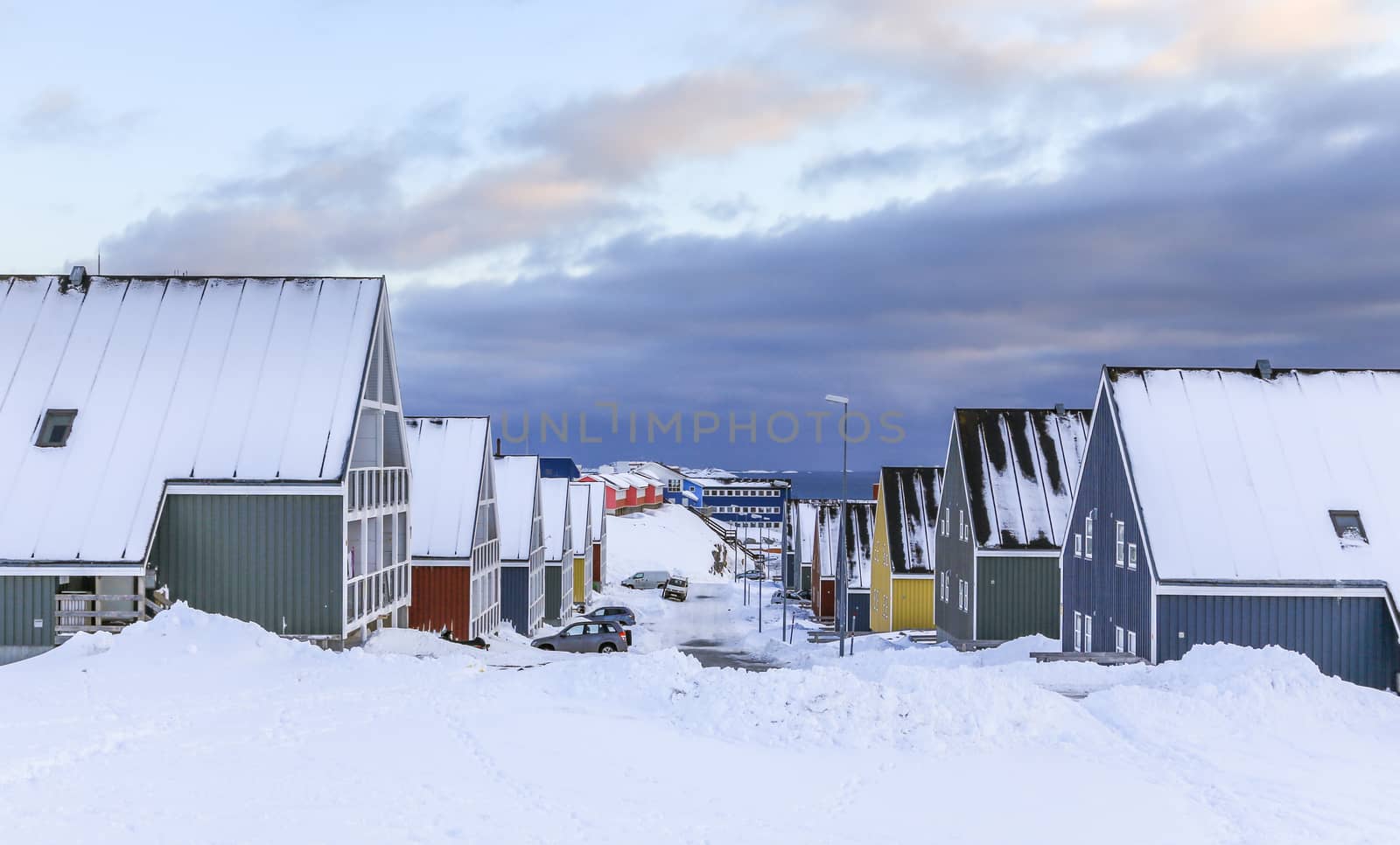 Street full of snow with colorful Inuit houses in  arctic Nuuk city, Greenland