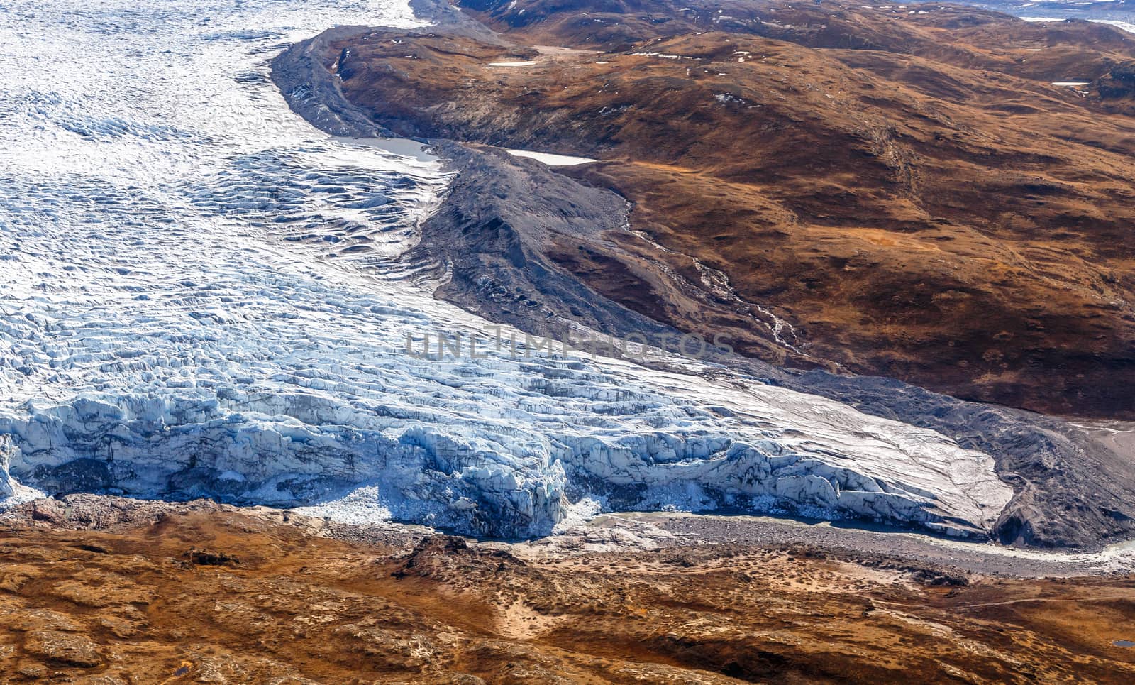 Greenlandic ice cap melting glacier with tundra aerial view, nea by ambeon