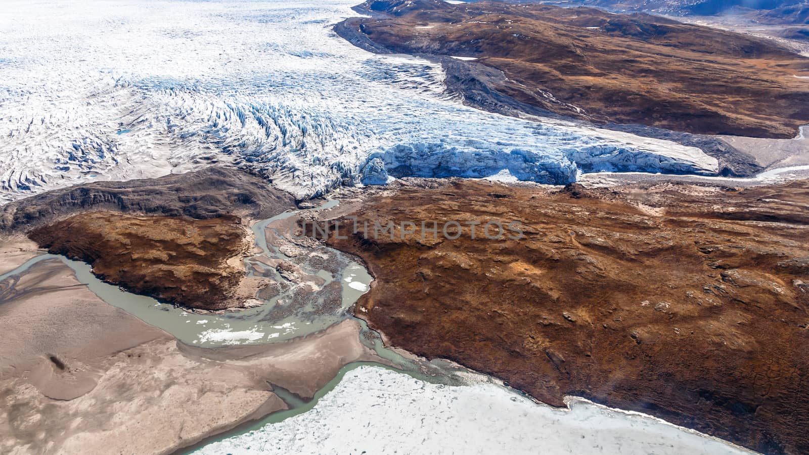 Greenlandic ice sheet melting glacier into river with tundra aer by ambeon