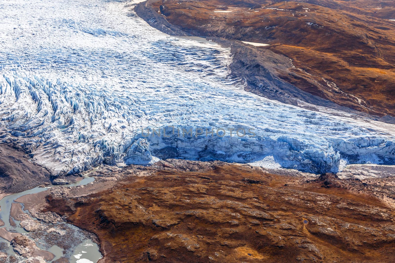 Greenlandic ice cap melting glacier with tundra aerial view, near Kangerlussuaq, Greenland