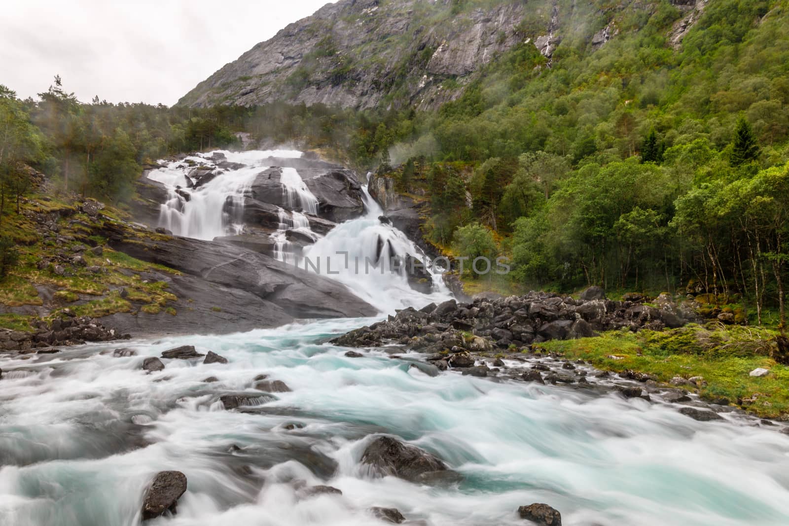 Tveitafossen waterfall powerful streams in Husedalen valley, Kin by ambeon