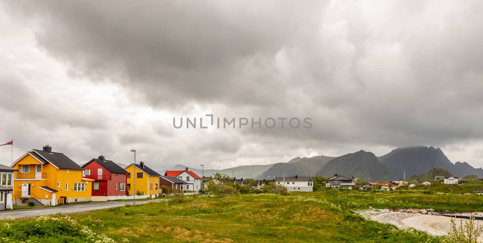 Yellow, red and white norwegian houses along the road in Andenes village, Andoy Municipality, Vesteralen district, Nordland county, Norway
