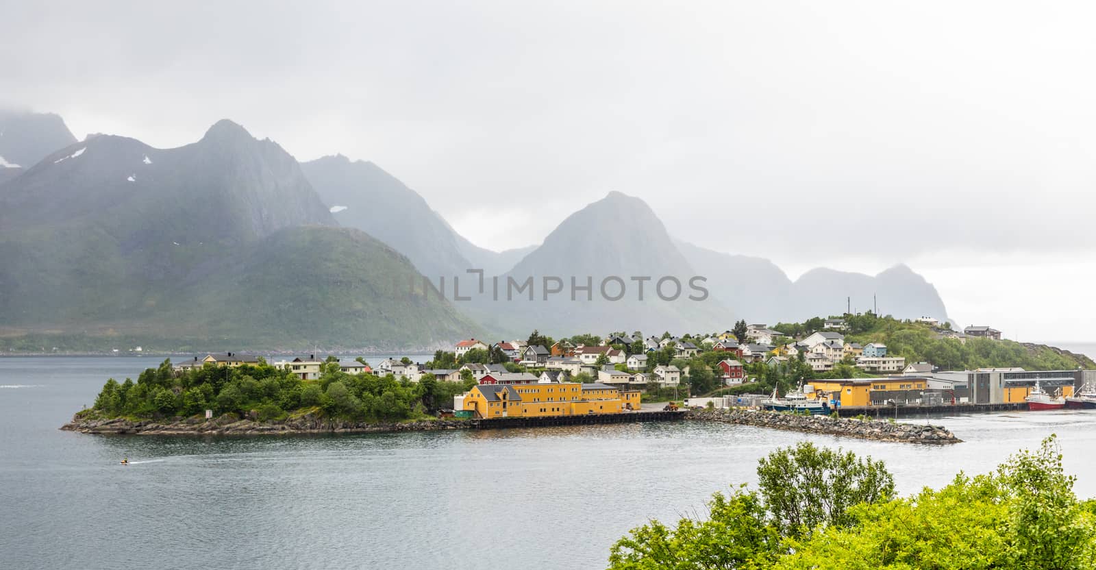 Husoy island village panorama with mountains in the background, Senja island, Troms county, Norway