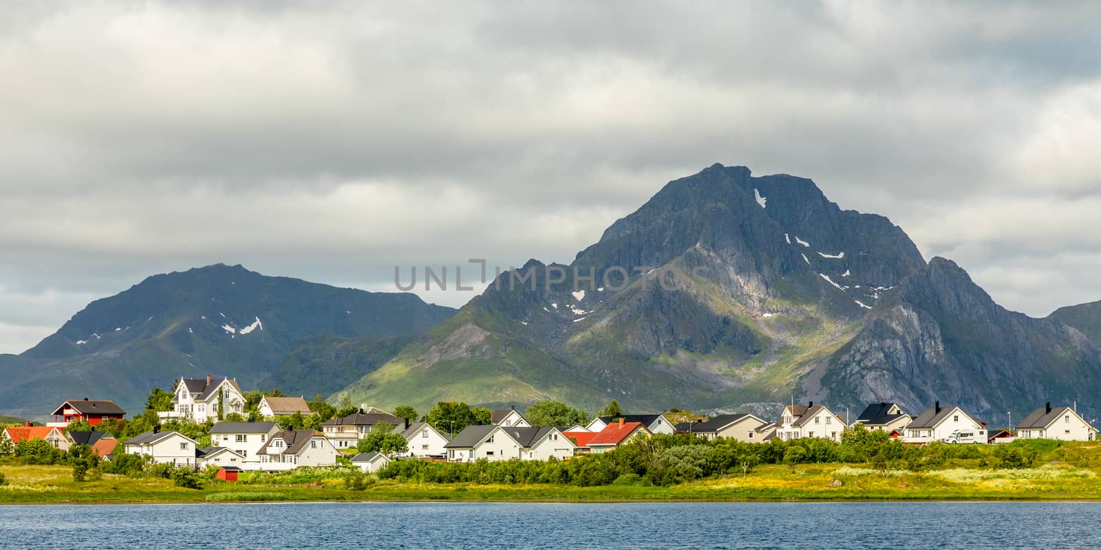 Norwegian houses and cottages at the lake with mountain in the b by ambeon