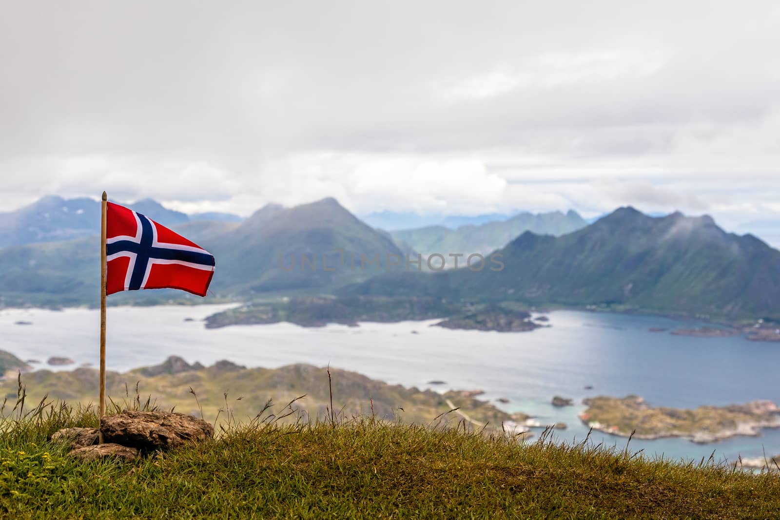 Norwegian national flag waiving in the wind on the top of Nonsti by ambeon