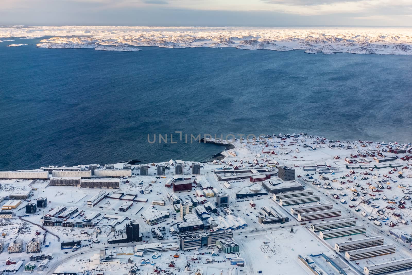 Aerial view to the fjord and snow streets of Greenlandic capital by ambeon